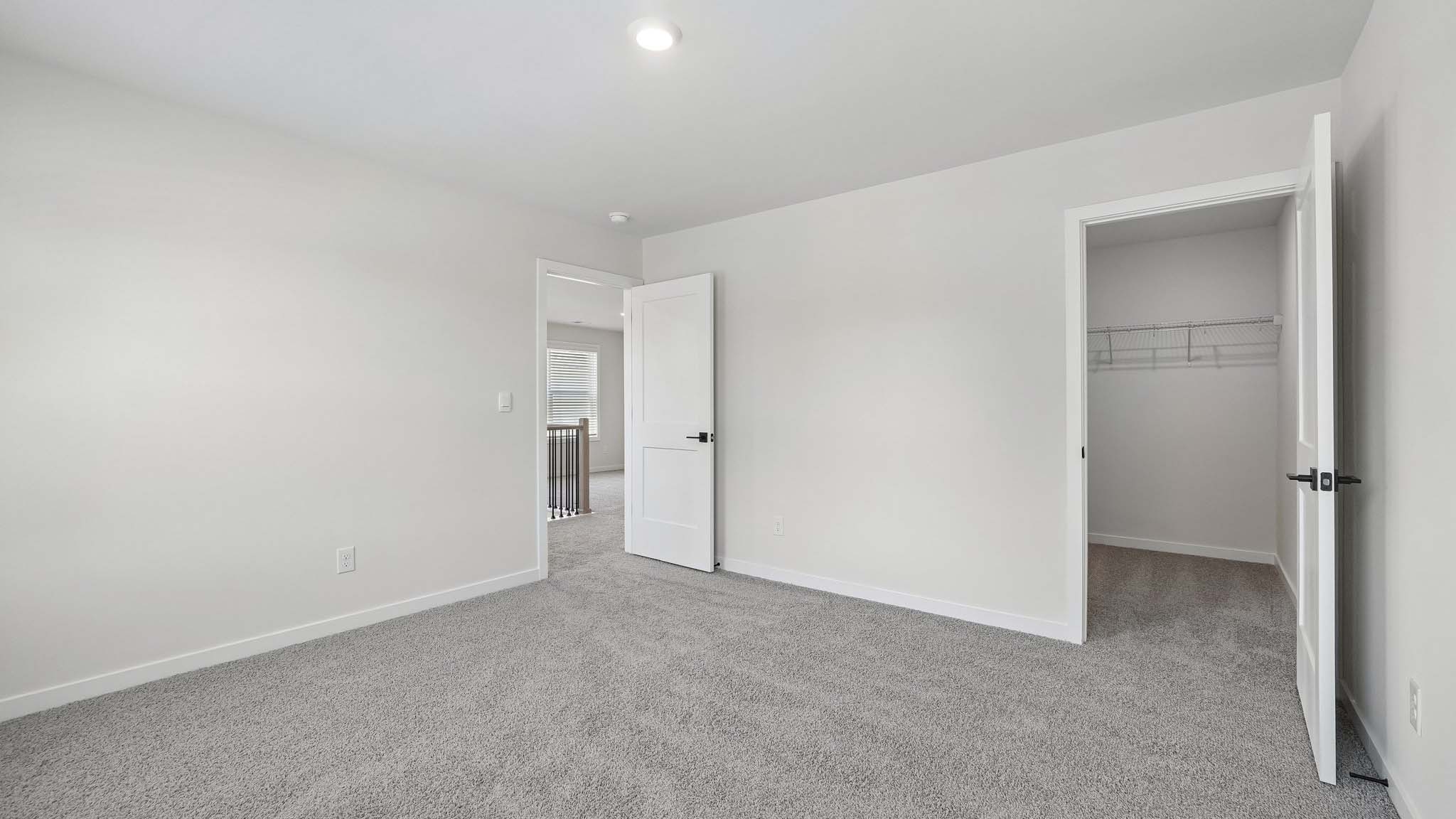 Carpeted bedroom with windows