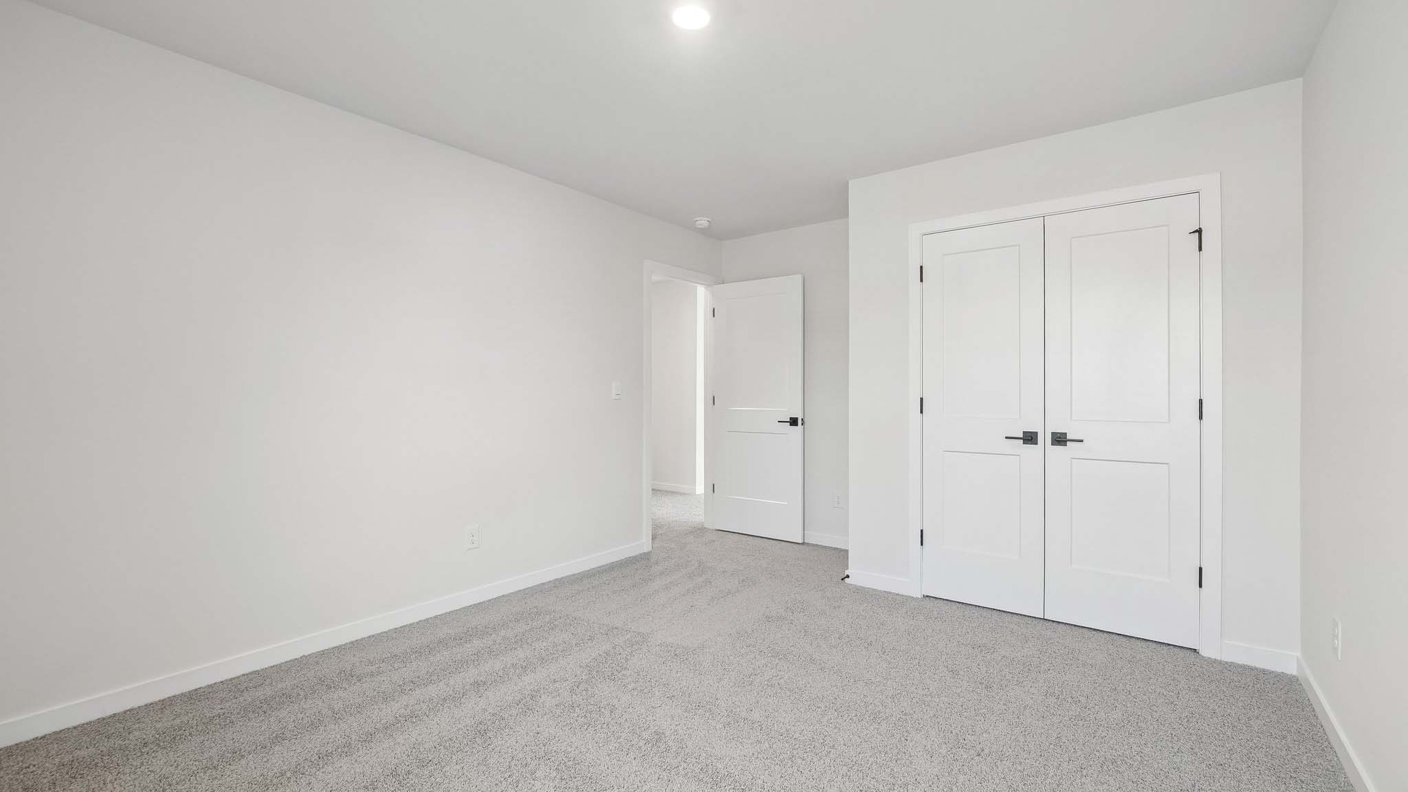 Carpeted bedroom with windows