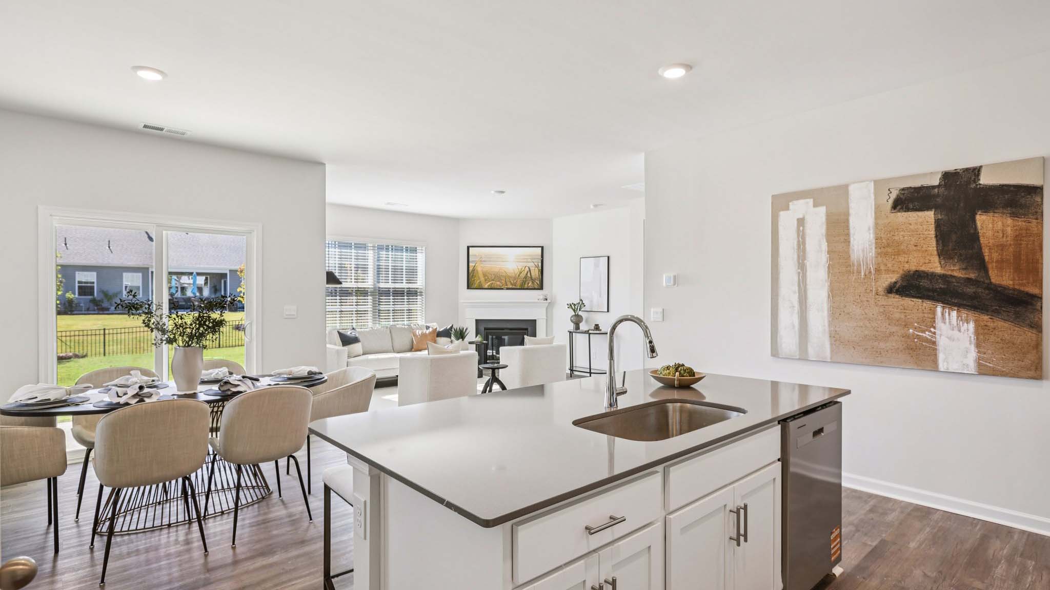 Kitchen and island with white cabinets and subway tiles and stainless steel subway tiles