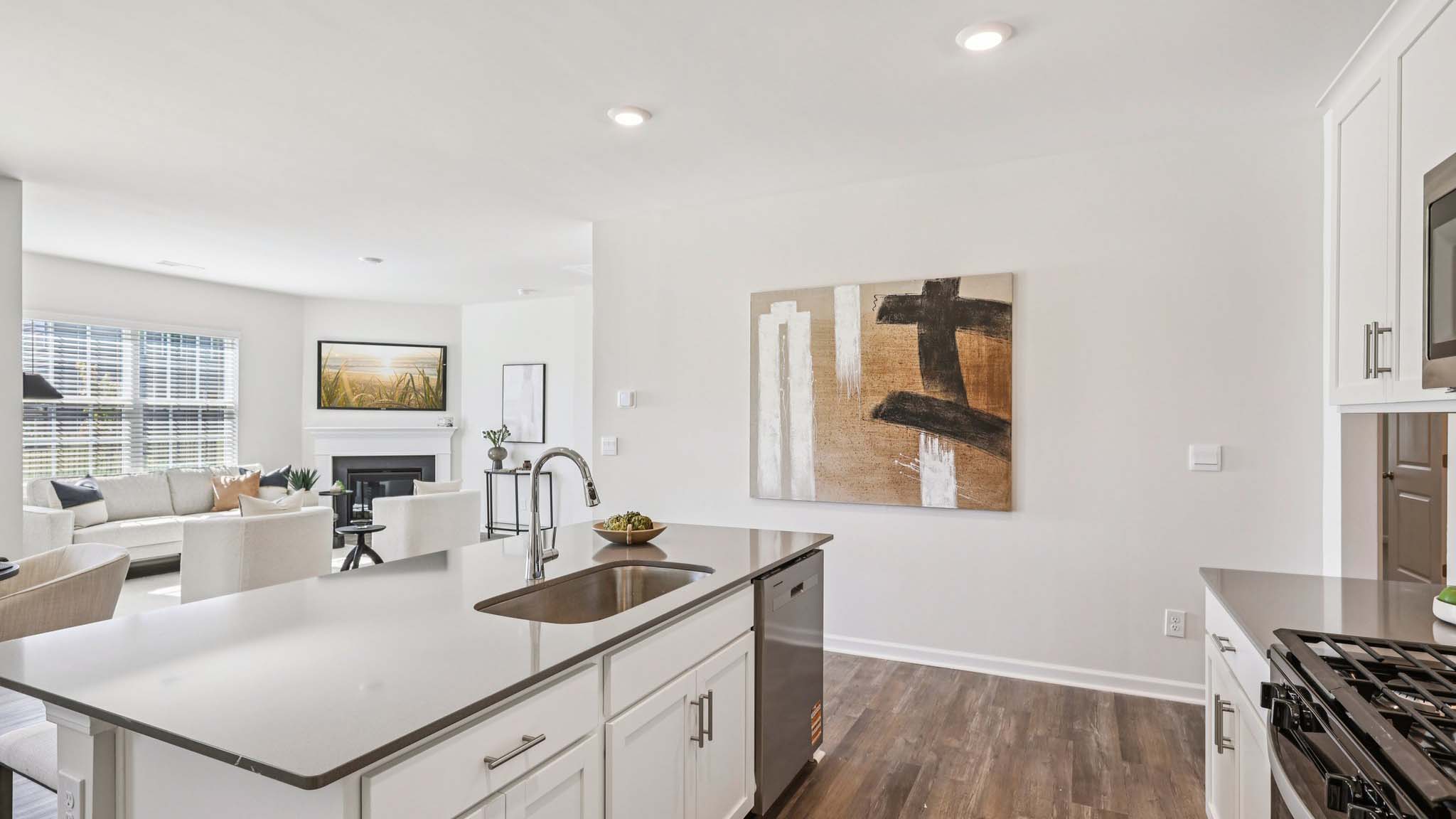 Kitchen and island with white cabinets and subway tiles and stainless steel subway tiles