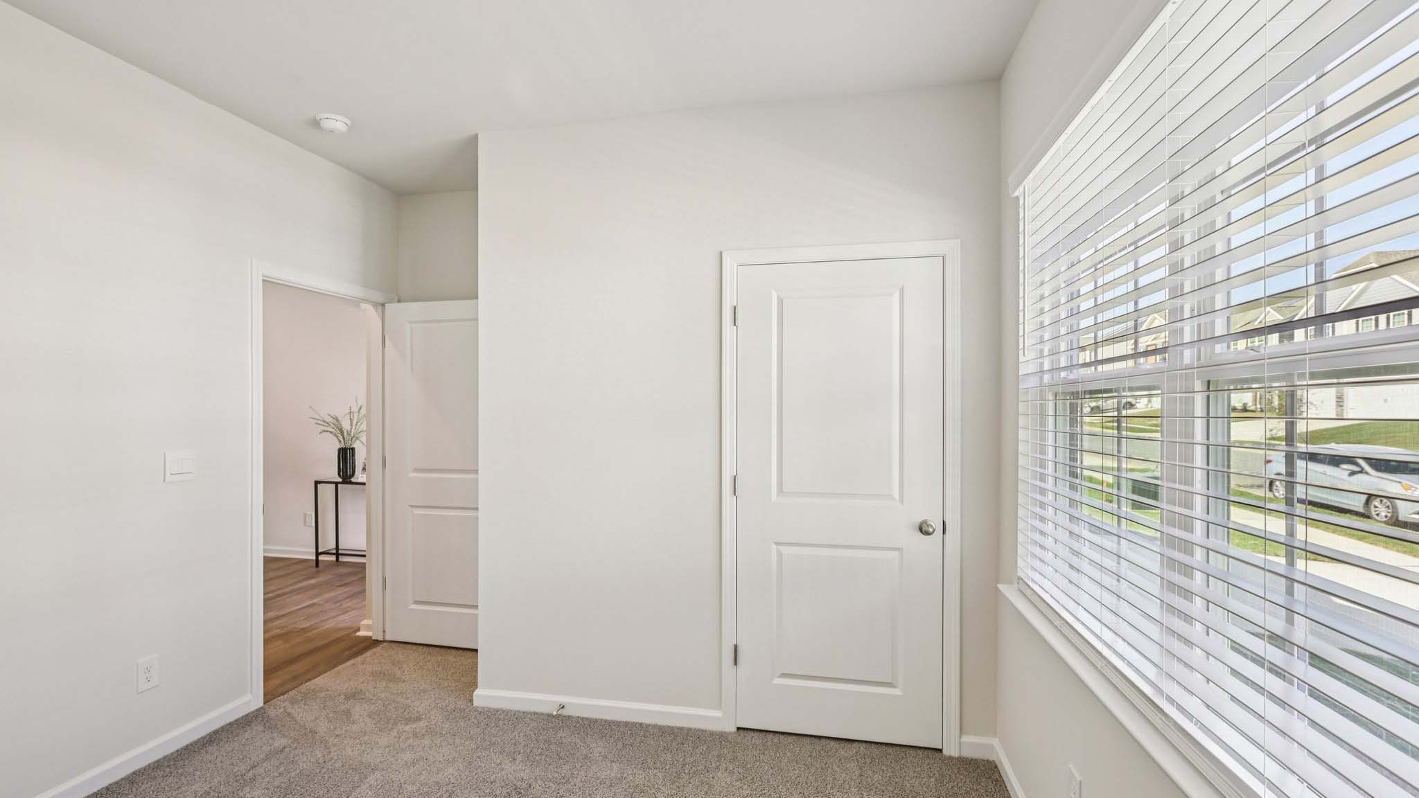 Carpeted bedroom with window