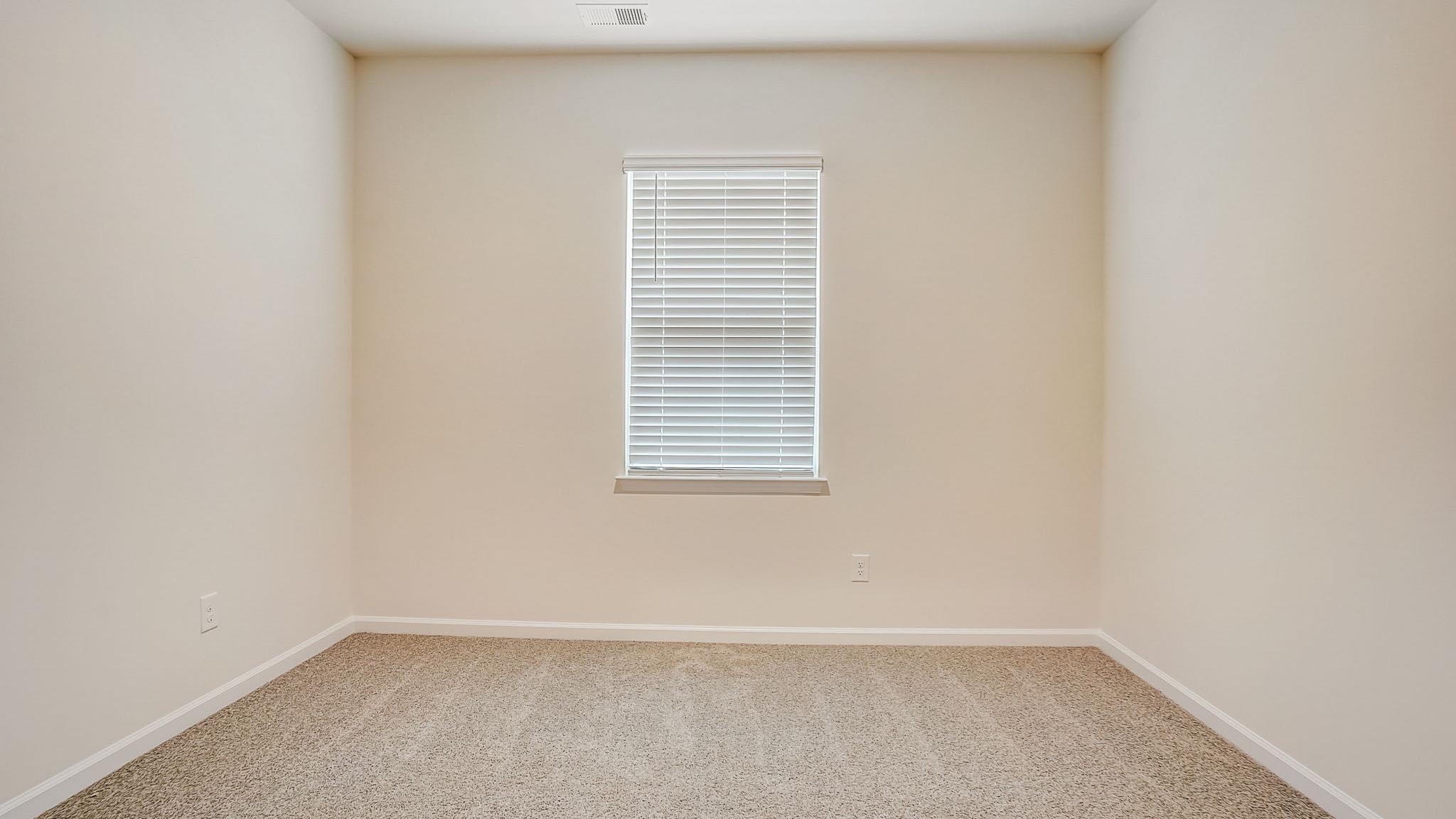 Carpeted bedroom with window