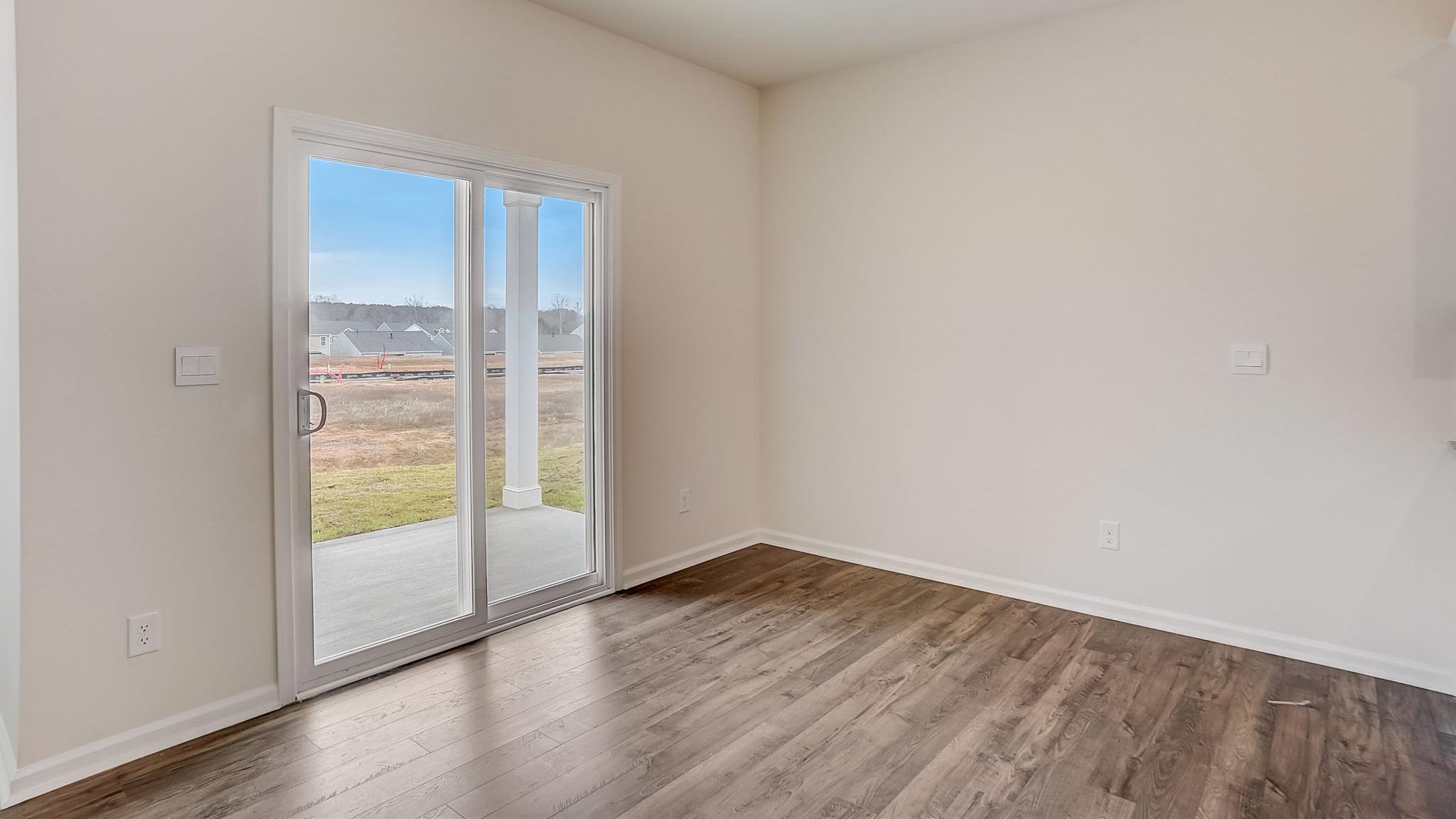 Dining area with wood floors and sliding glass back door