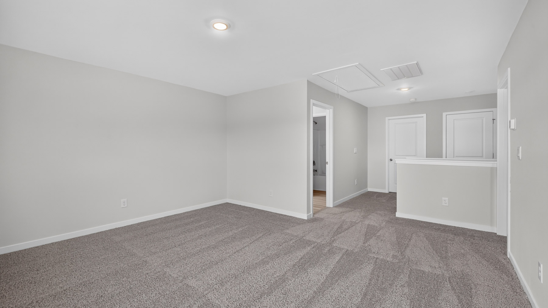 Upstairs carpeted loft with windows