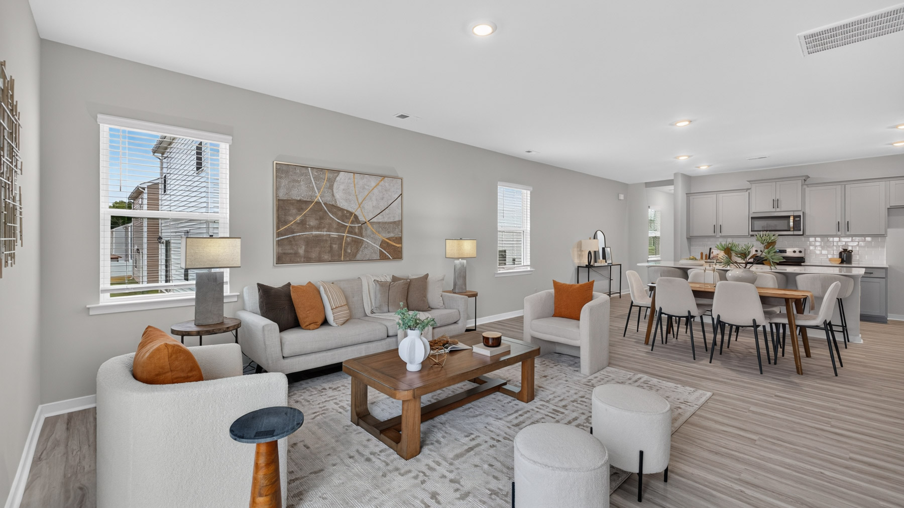 Open living room with fire place, vinyl floors, and large window