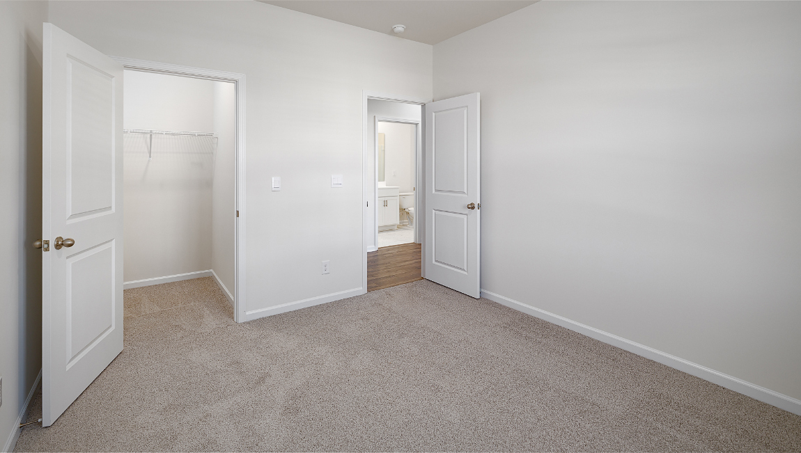 Carpeted bedroom with small window