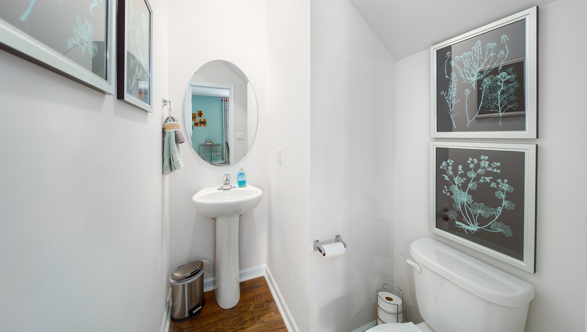 Powder bathroom with small white sink and toilet