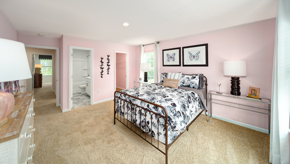 Carpeted bedroom with two large windows