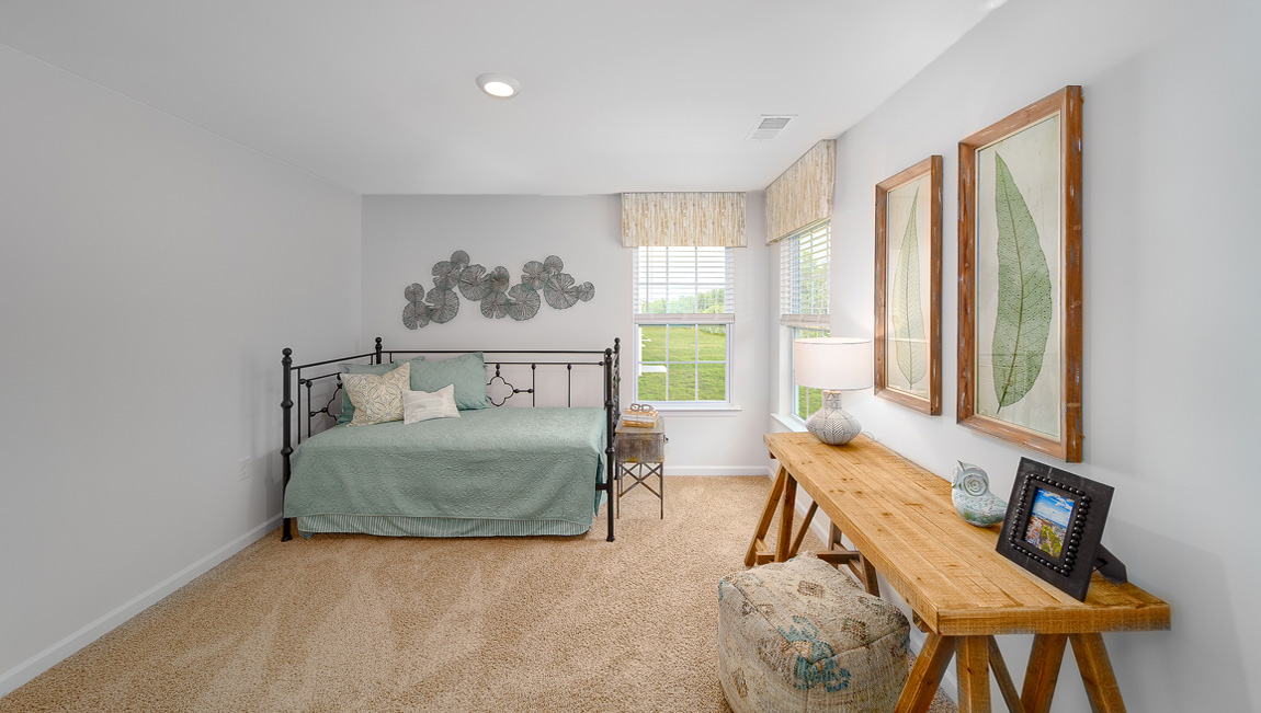 Carpeted bedroom with two large windows