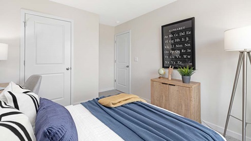 Carpeted bedroom with large windows