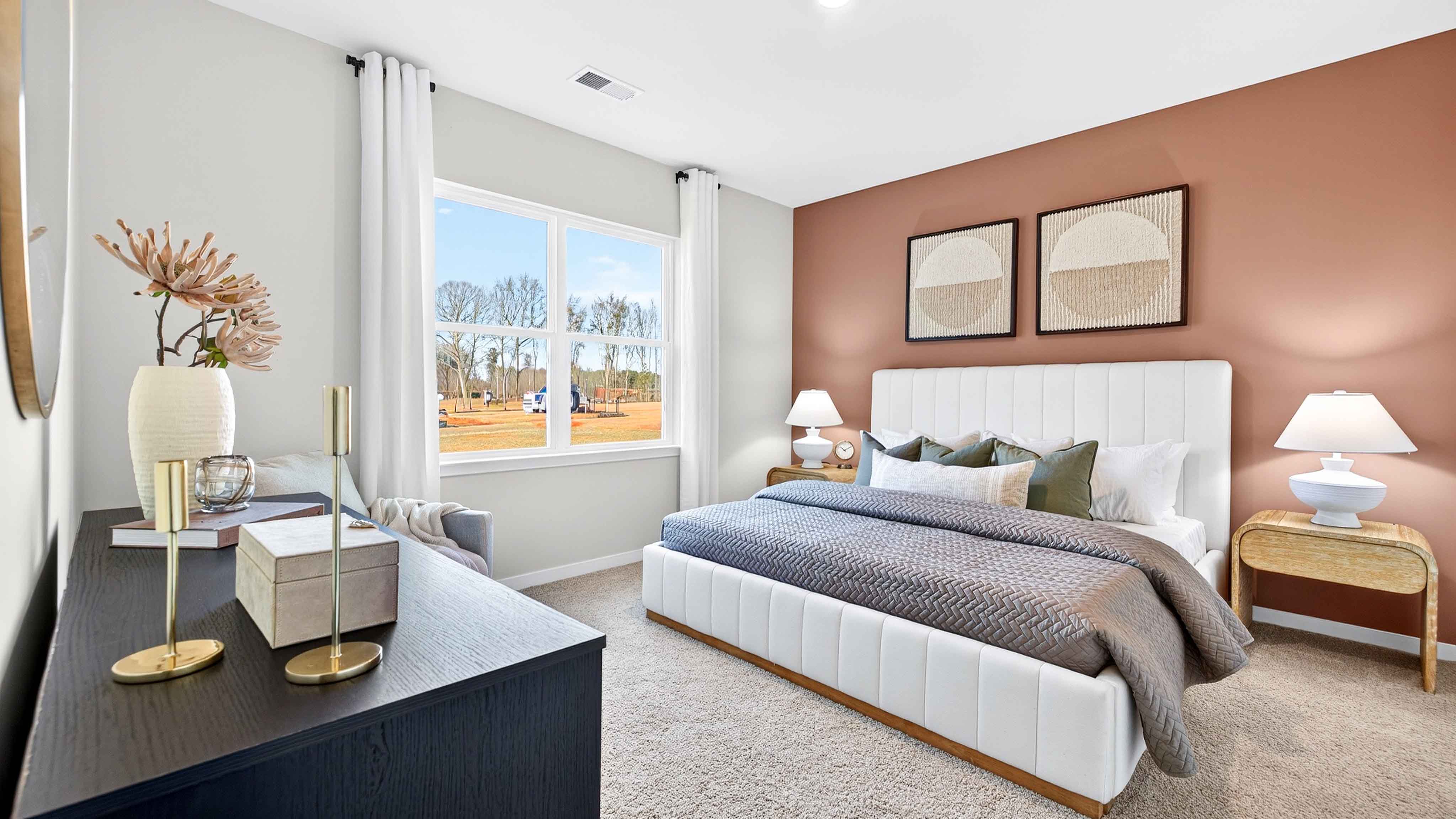 Primary carpeted bedroom with windows