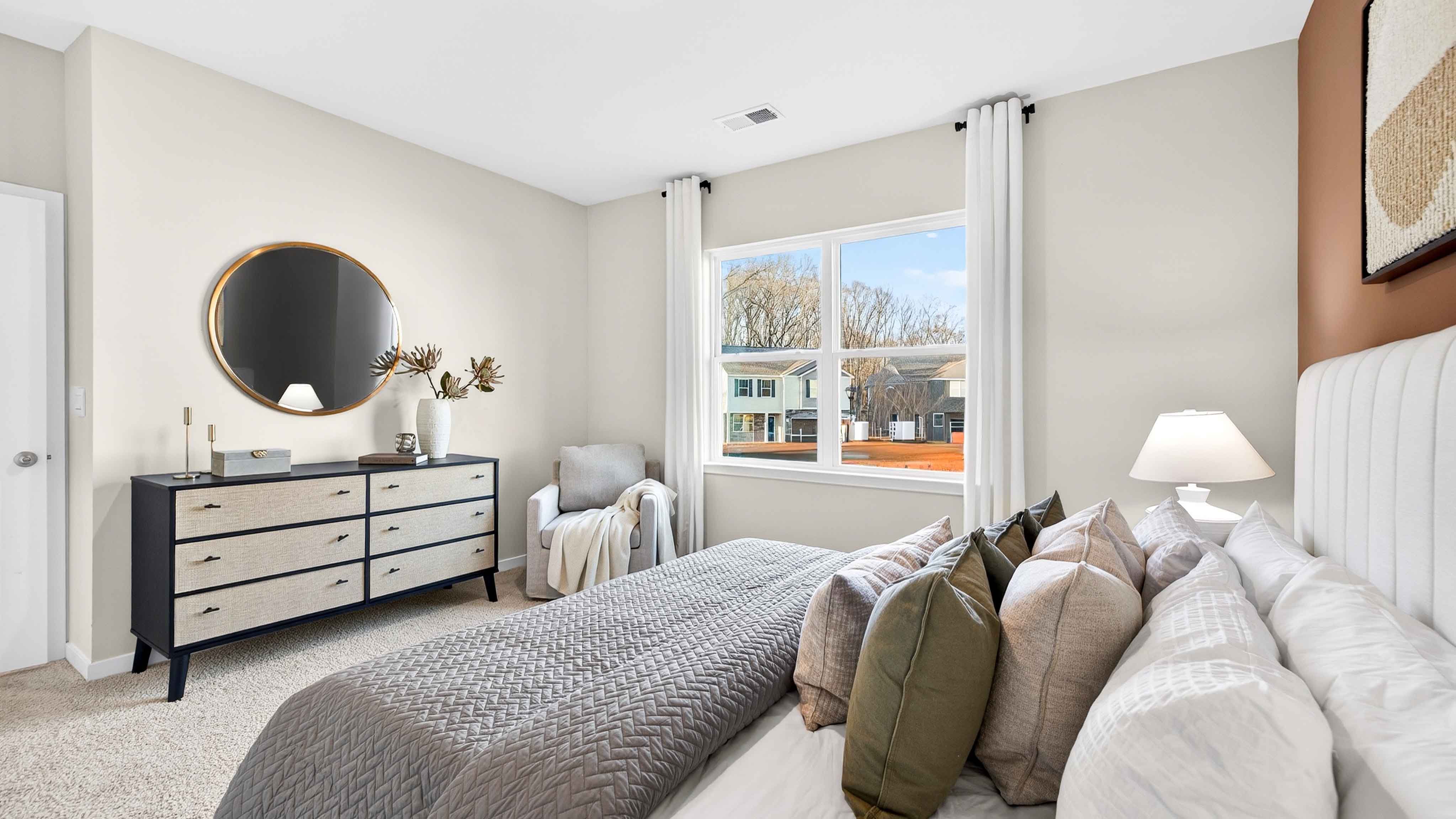 Primary carpeted bedroom with windows