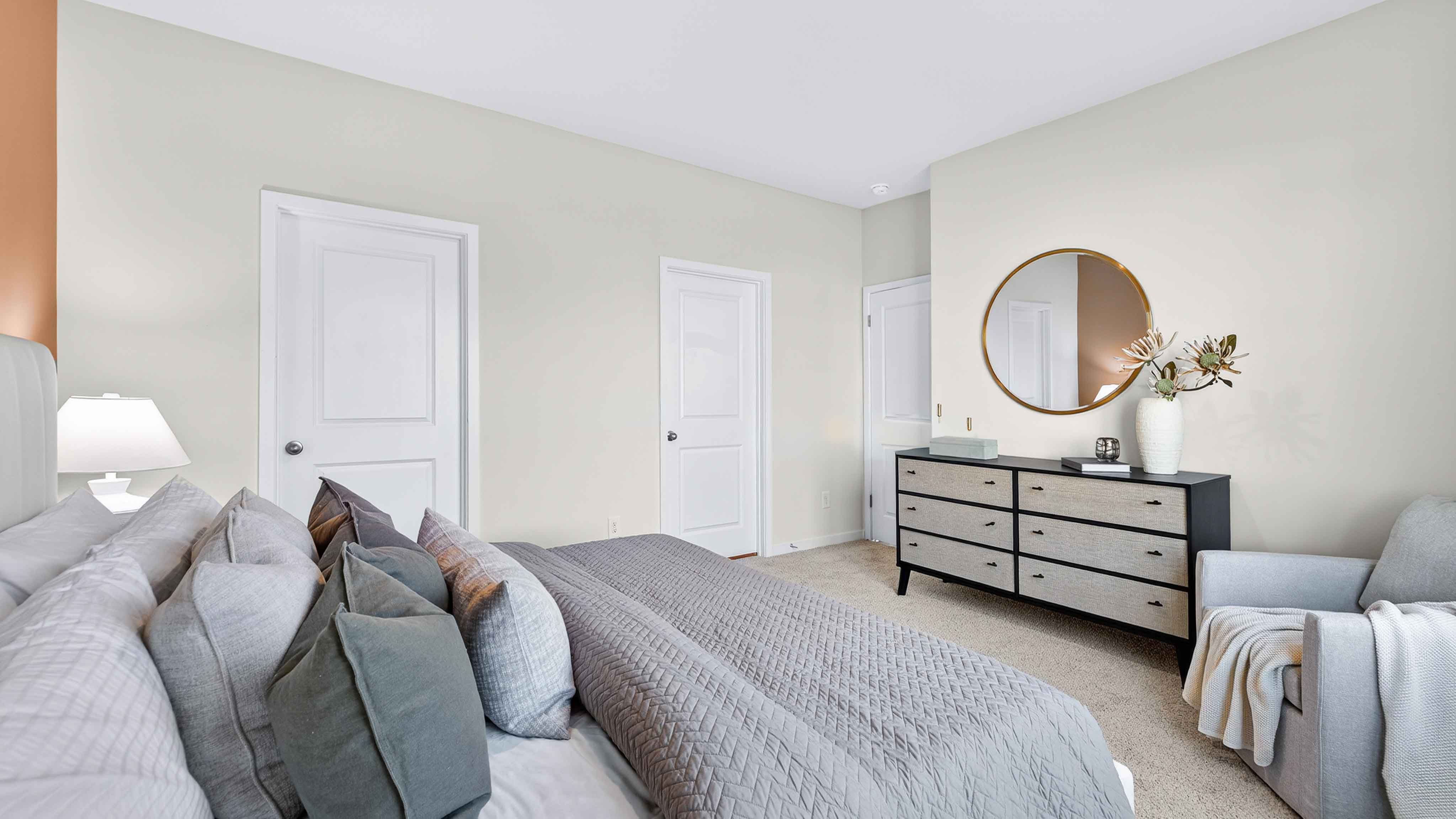 Primary carpeted bedroom with windows