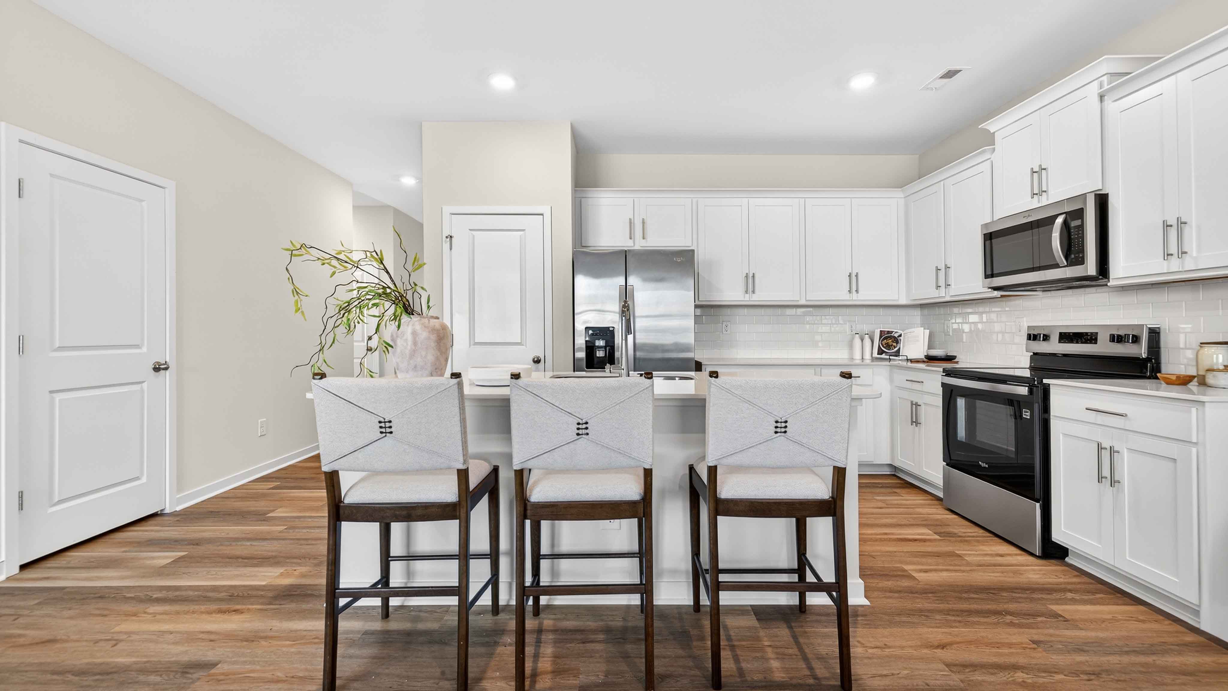 Open kitchen and island with white cabinets