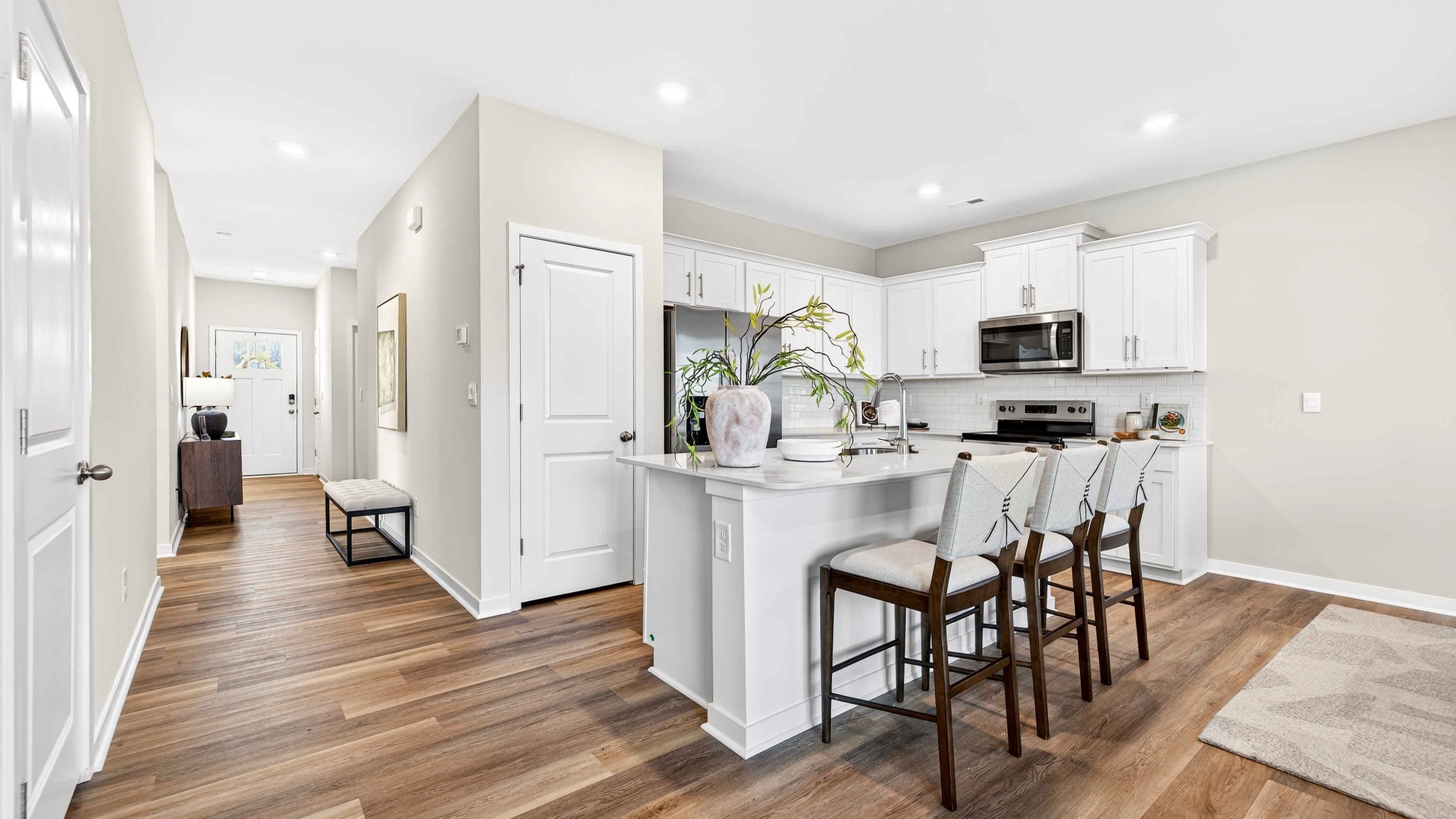 Open kitchen and island with white cabinets