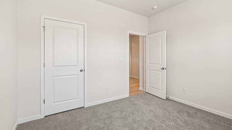 Carpeted bedroom with large window