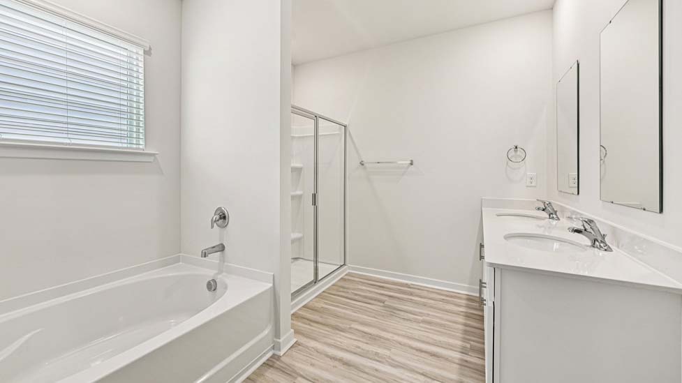 Bathroom with soaking tuyb, wlak in shower, and double sink vanity