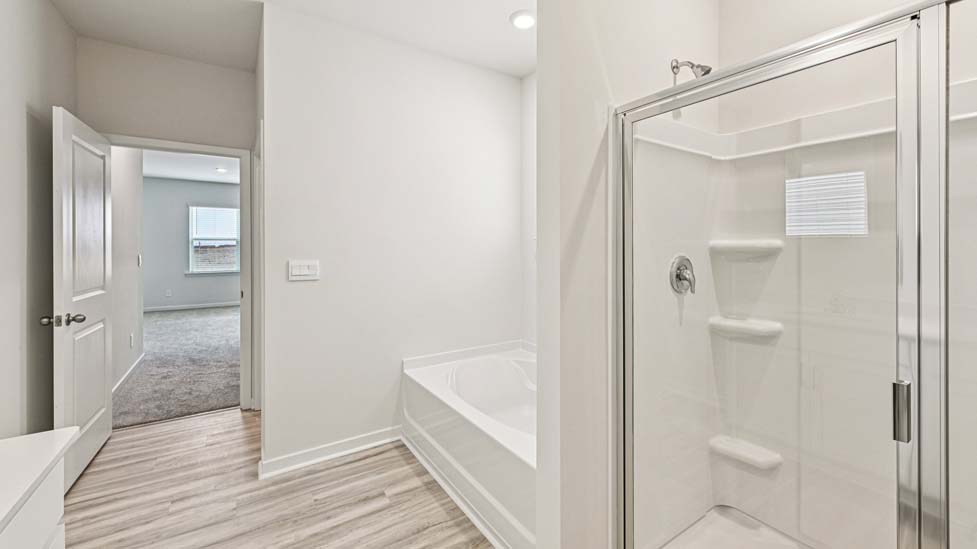 Bathroom with soaking tuyb, wlak in shower, and double sink vanity