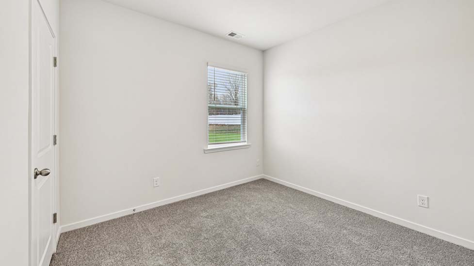 Carpeted bedroom with large window