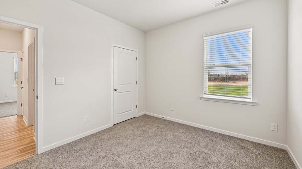 Carpeted bedroom with large window