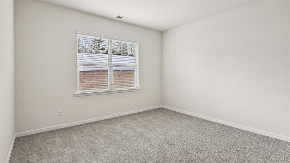 Carpeted bedroom with large window