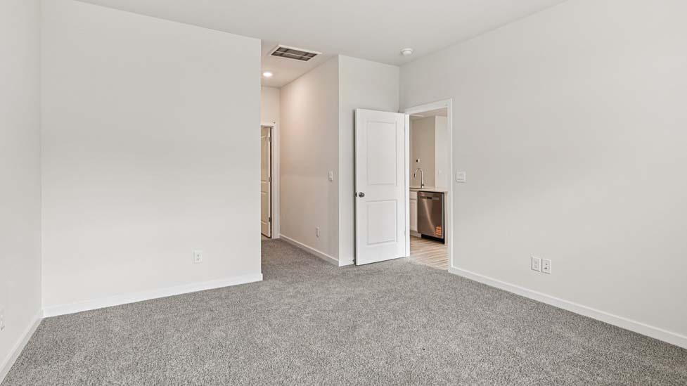 Carpeted bedroom with large window