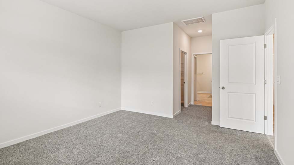 Carpeted bedroom with large window