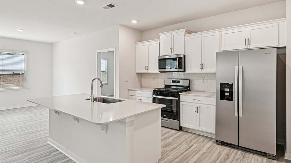 Kitchen and island with stainless steel appliances