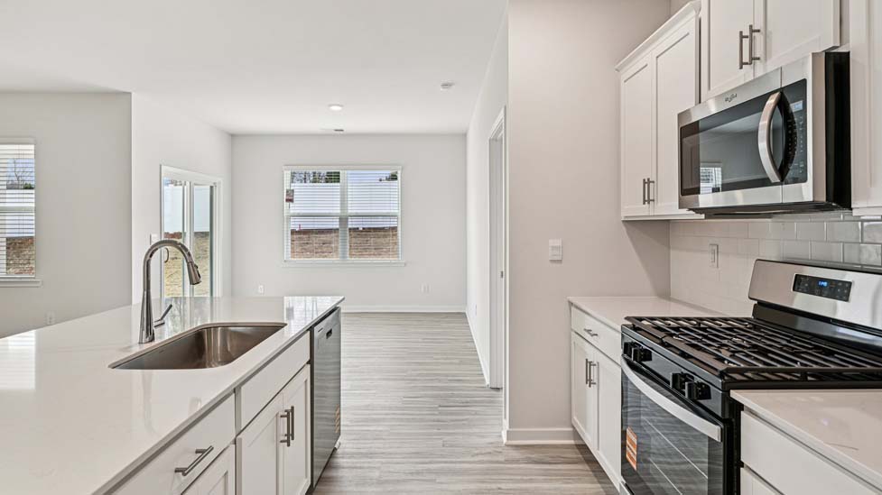 Kitchen and island with stainless steel appliances