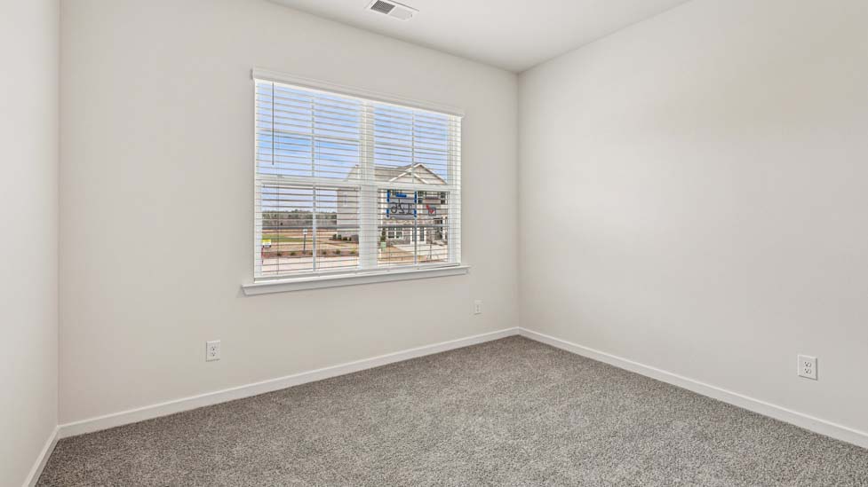 Carpeted bedroom with large window