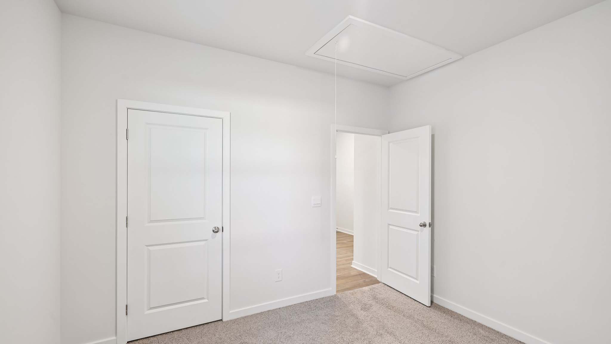Carpeted bedroom with windows