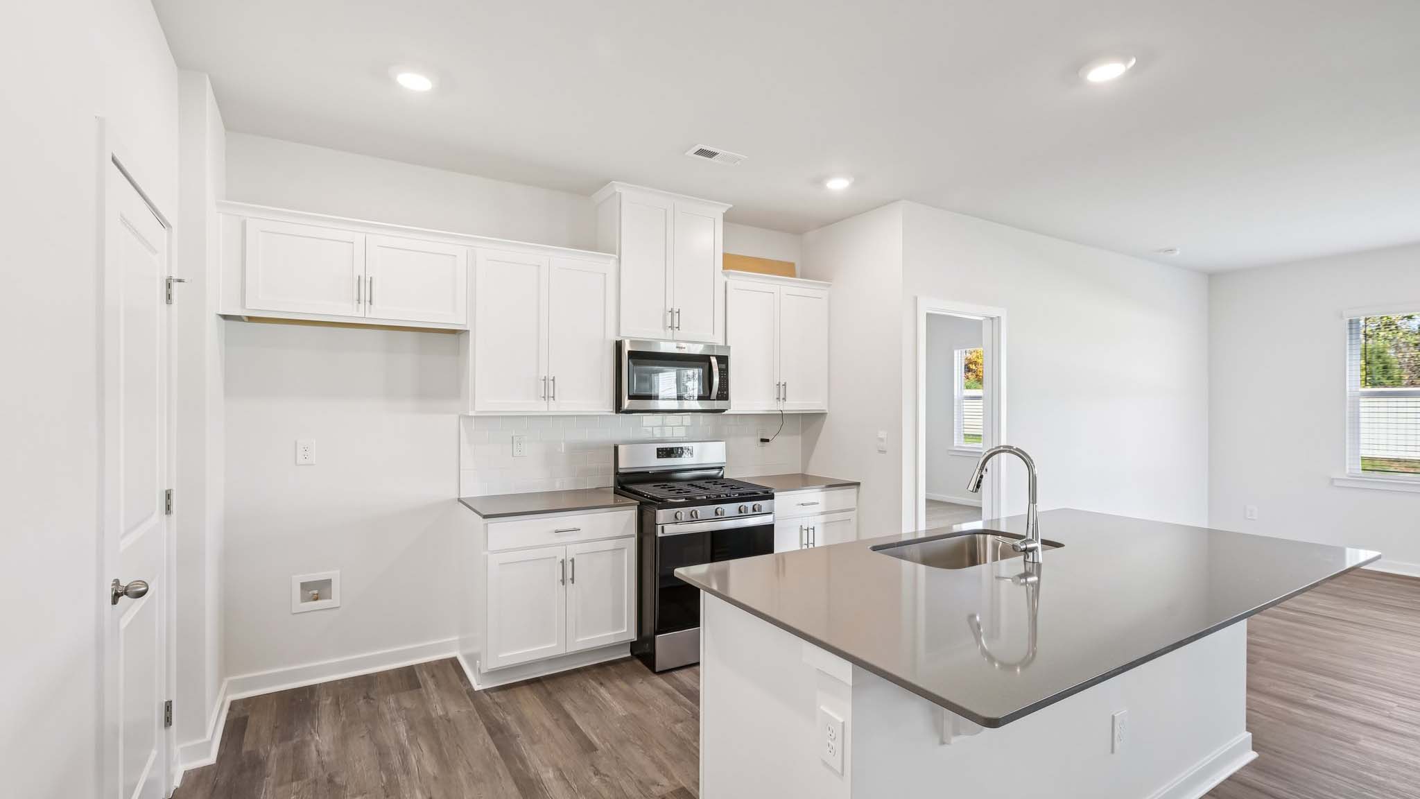 Kitchen and island with stainless steel appliances