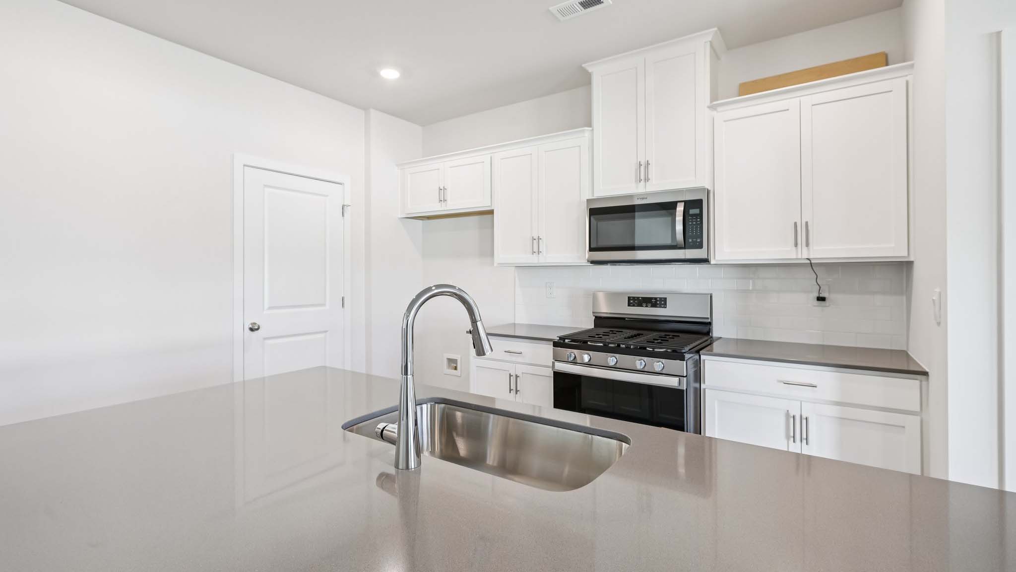 Kitchen and island with stainless steel appliances