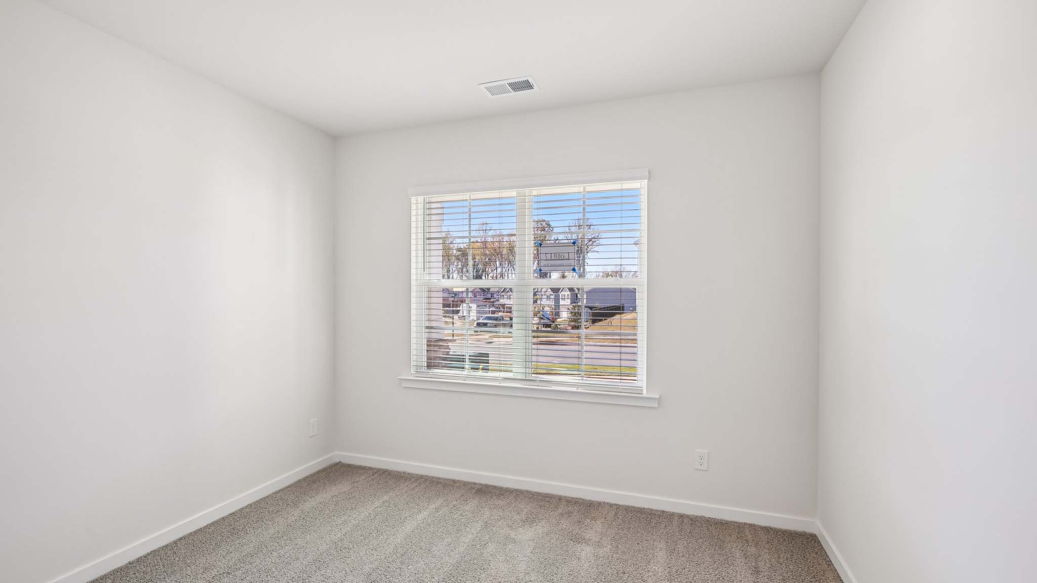 Carpeted bedroom with windows