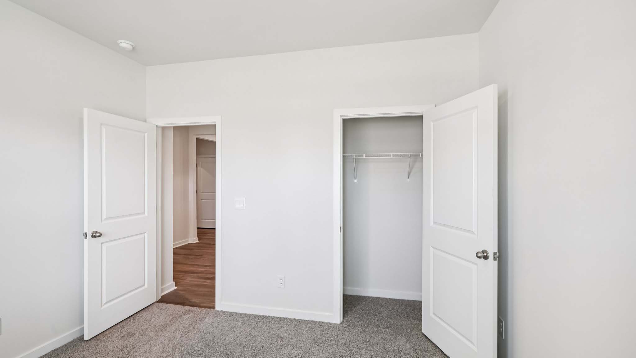 Carpeted bedroom with windows