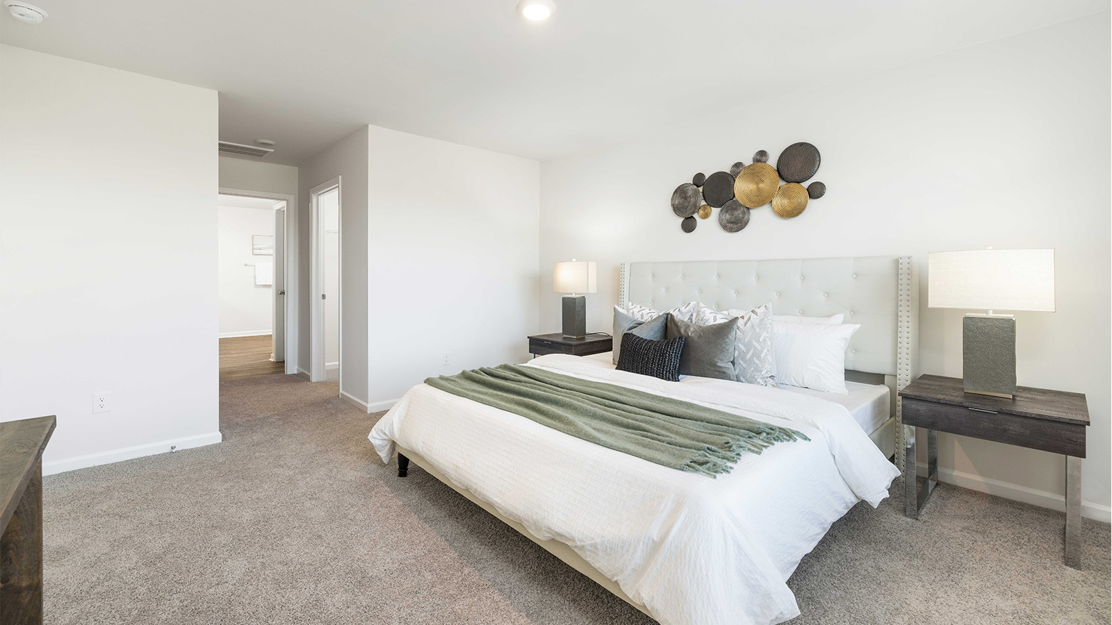Primary carpeted bedroom with windows