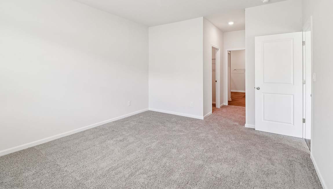 Carpeted bedroom with large window