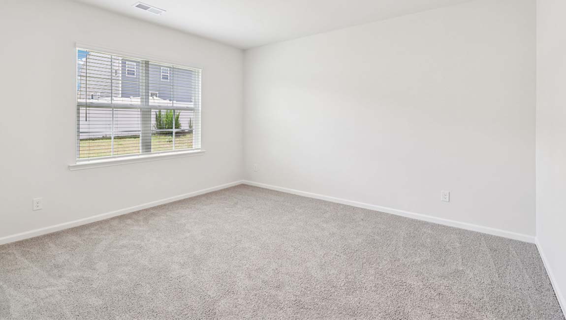 Carpeted bedroom with large window