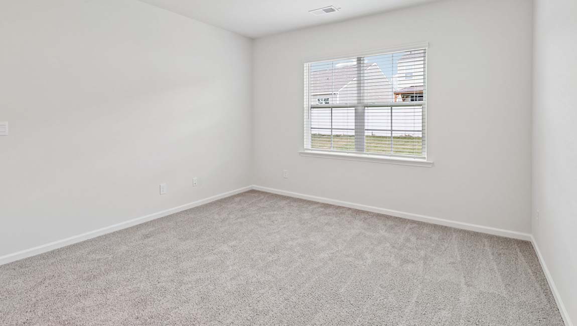 Carpeted bedroom with large window