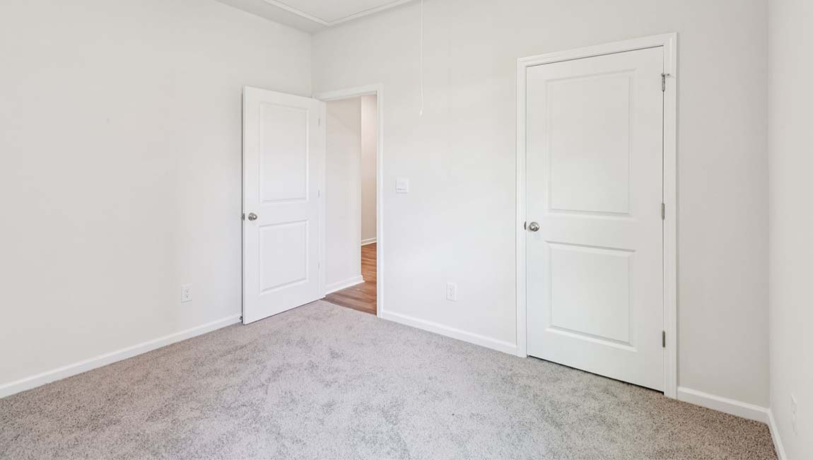 Carpeted bedroom with large window