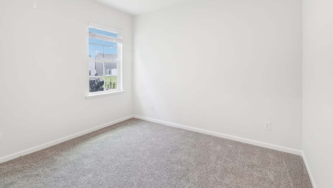 Carpeted bedroom with large window