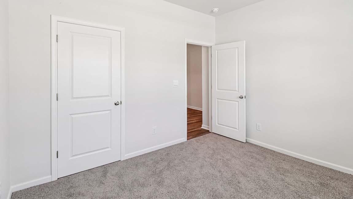 Carpeted bedroom with large window
