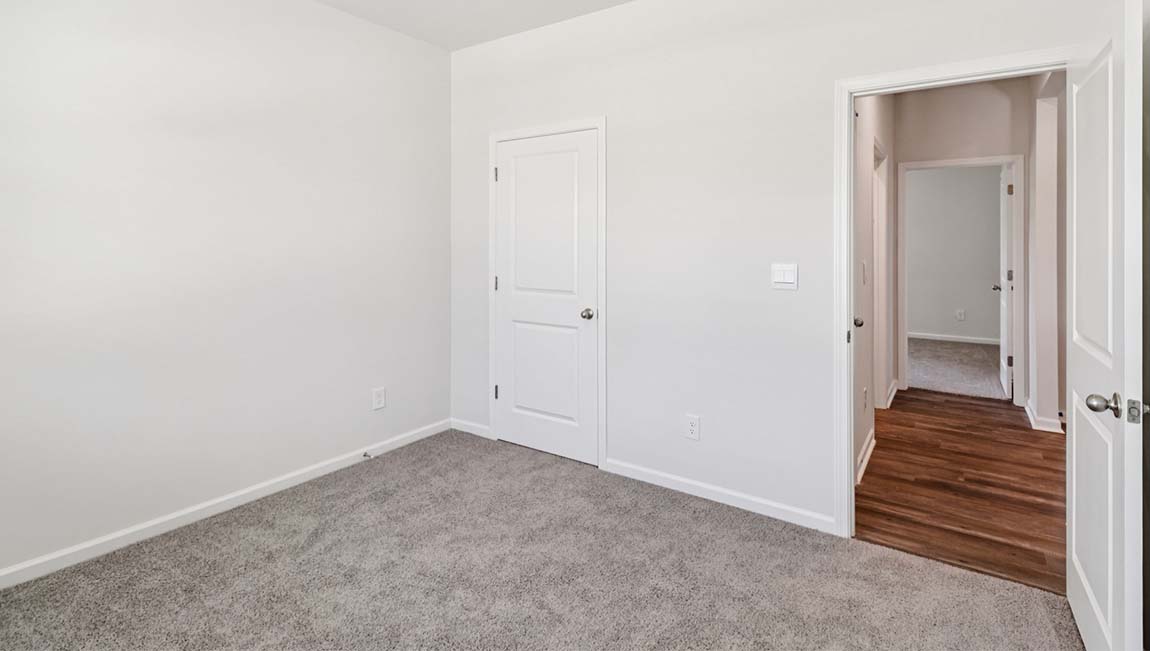 Carpeted bedroom with large window