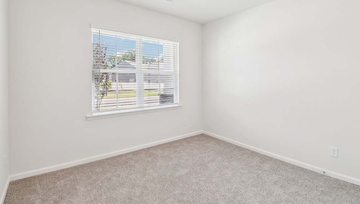Carpeted bedroom with large window