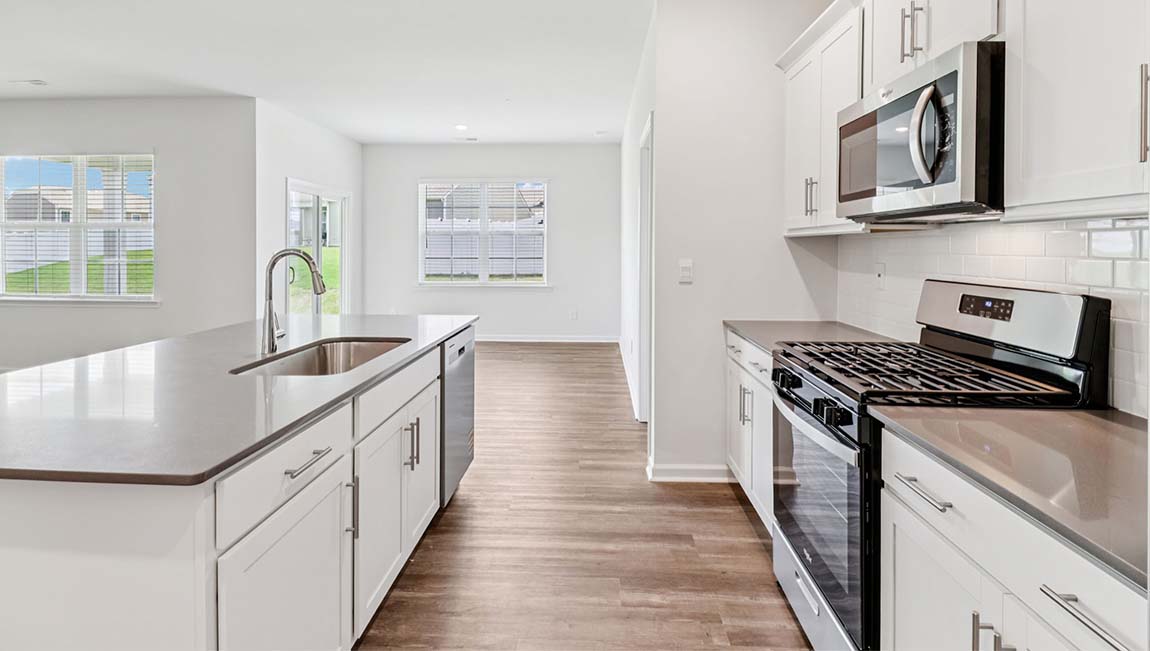 Kitchen and island with stainless steel appliances