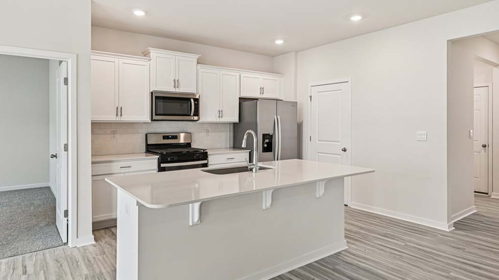 Kitchen and island with stainless steel appliances