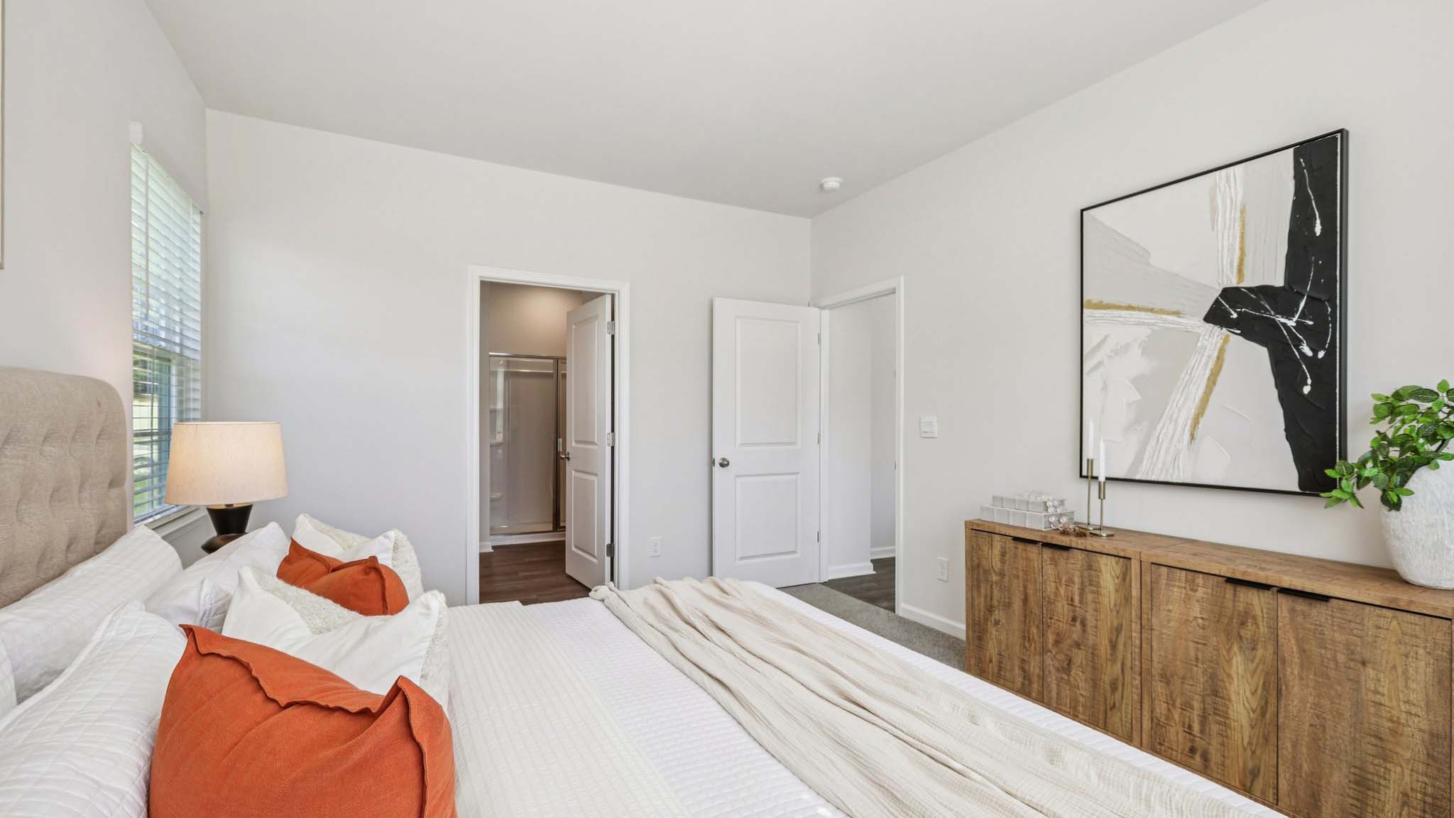 Primary carpeted bedroom with windows