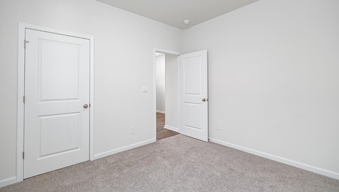 Carpeted bedroom with windows