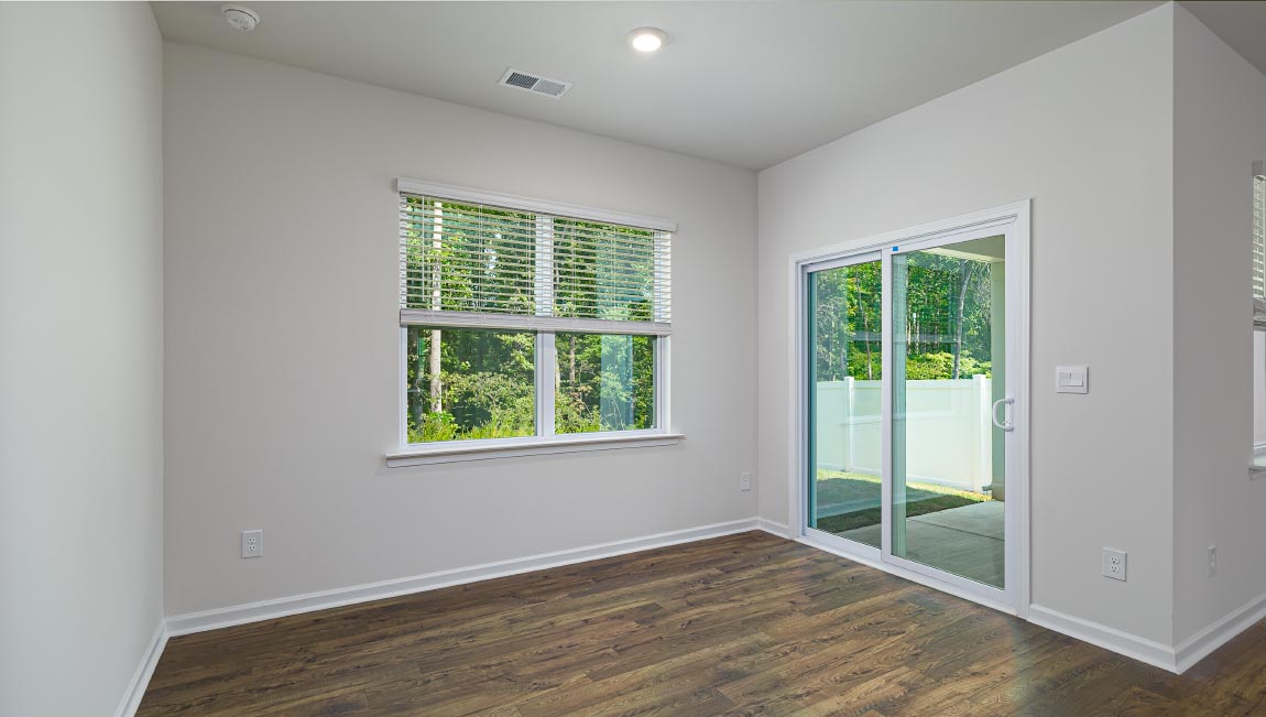 Dining area with wood floors and sliding glass back door