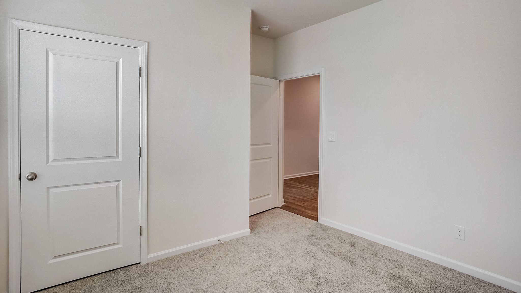 Carpeted bedroom with large window